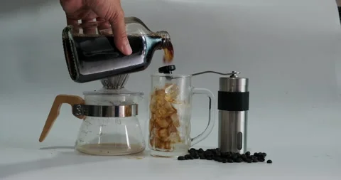 Cold brew arabica coffee pour into ice glass with coffee make equipment Stock Footage 142745182