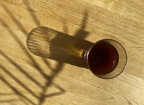 Cold brew coffee, iced cool fresh drink on wooden table on sunny day, top vie Stock Photos