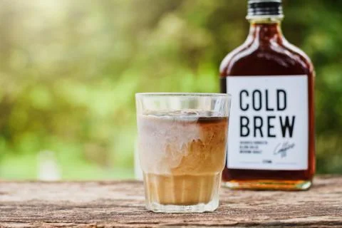 Cold brew coffee with milk on a table outside with cold-brew coffee in a glass Stock Photos