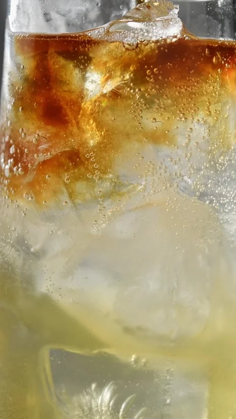 Cold brew coffee spreads over sparkling apple cider and tonic with ice in Stock Footage 345487004