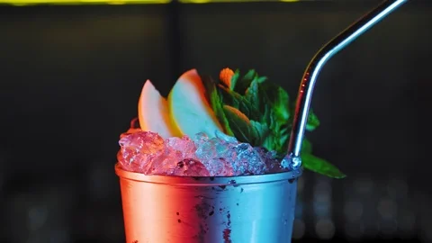 Cold cocktail with lime, tonic, vodka and ice on dark background. 4K Stock Footage 99312663