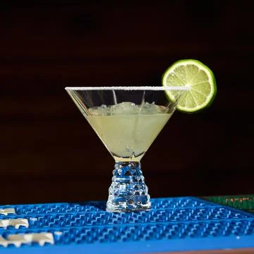 Cold coctails with lime, mint and ice in a glass with drops. Alcohol drink at Stock Photos