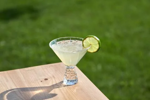 Cold coctails with lime, mint and ice in a glass with drops. Alcohol drink at Stock Photos