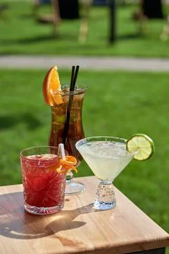 Cold coctails with lime, mint and ice in a glass with drops. Alcohol drink at Stock Photos