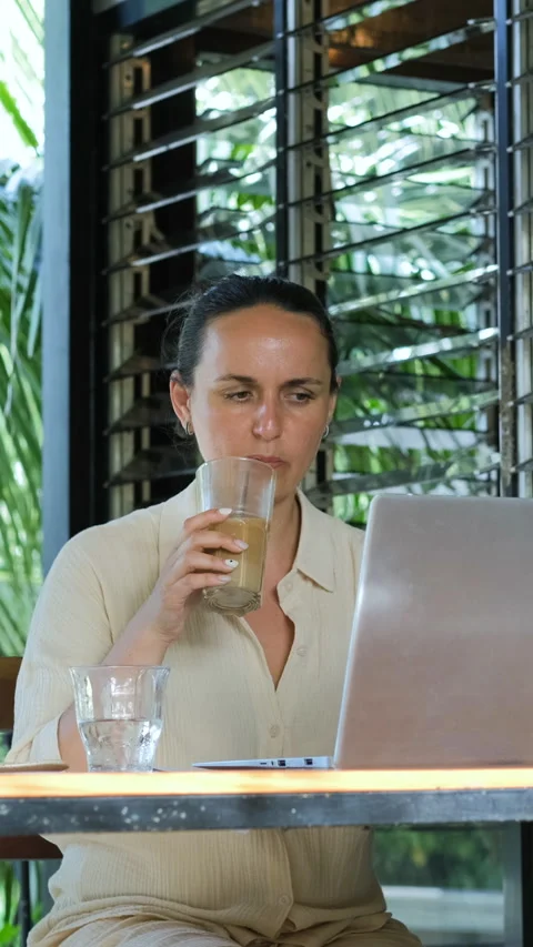 Cold coffee and laptop work on tropical terrace Stock Footage 315294406