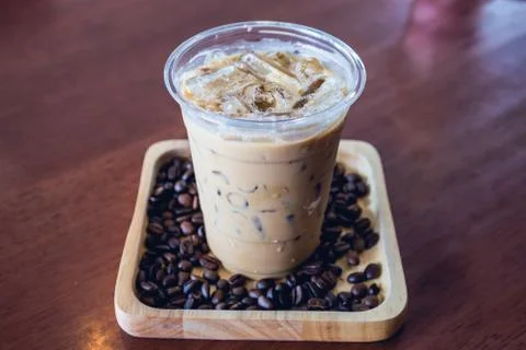 Cold coffee drink frappe or frappuccino in wooden tray with coffee bean Stock Photos