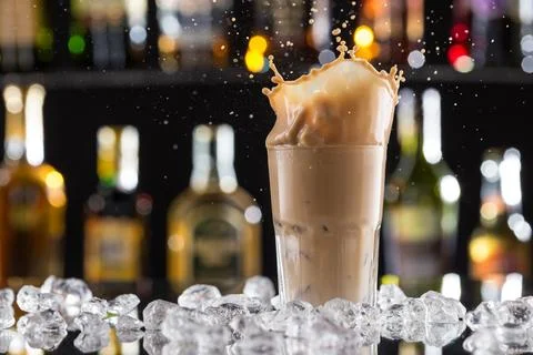 Cold coffee drink with ice, beans and splash, close-up. Stock-Fotos
