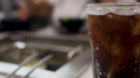 Cold Cola Drink with Ice at an Asian Barbecue Restaurant Stock Footage 334282825