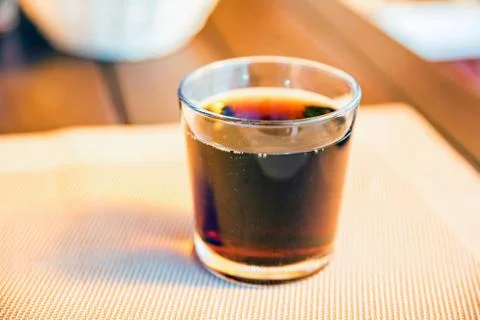 Cold cola in a glass on a table 写真素材