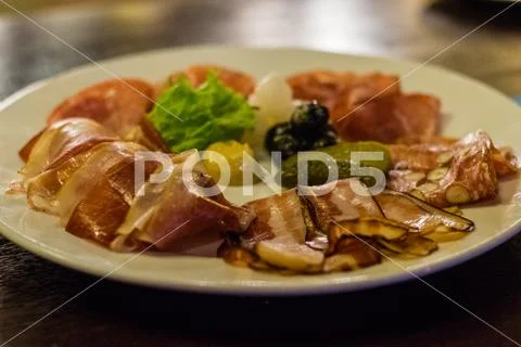 Cold cut meat platter with mustard, gherkins, pickles and pickled onions Stock Photos