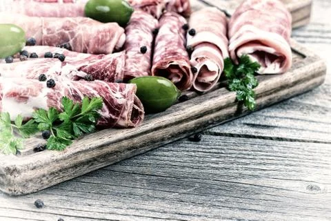Cold cut meats on serving board in vintage style Stock Photos