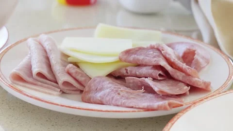 Cold cut platter with sliced ham salami and Swiss cheese 動画素材 338202339