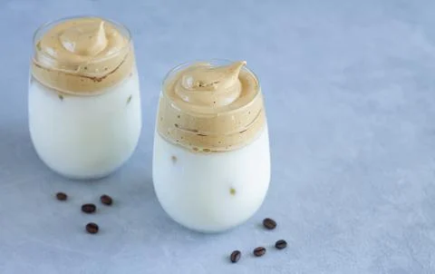 Cold Dalgon Coffee with ice and milk in glasses. Whipped Korean cuisine coffe Stock Photos