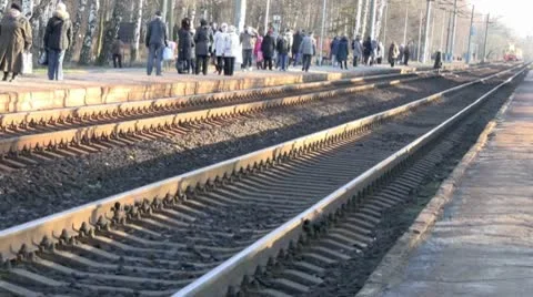 On a cold day, a crowd of warmly dressed people at the station greets an arrivin Stock Footage 10584469