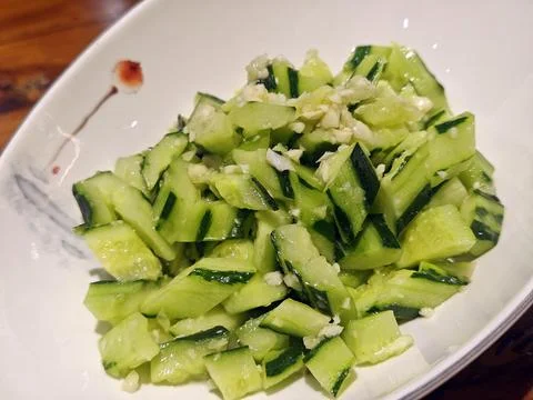 Cold dish features smashed cucumbers tossed with minced garlic Фото