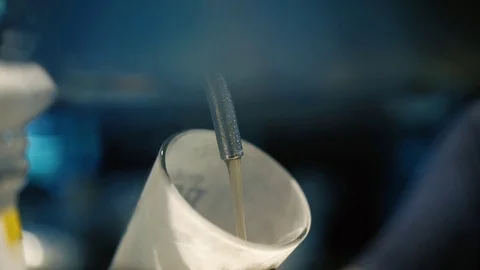 Cold draft beer poured into glass from silver beer dispenser, selective focus Stock Footage 109370387