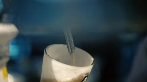 Cold draft beer poured into glass from silver beer dispenser, selective focus Stock Footage 109370388
