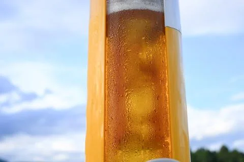 Cold draft beer serve in a transparent plastic tower cup Stock Photos