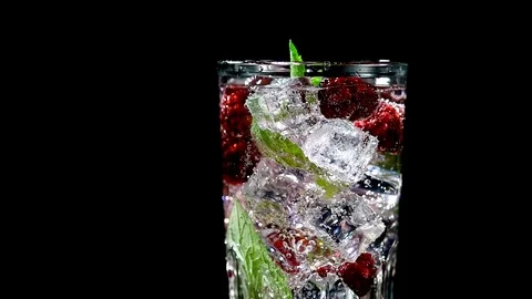 Cold drink with blackberries and mint on a black background closeup Stock Footage 91893507