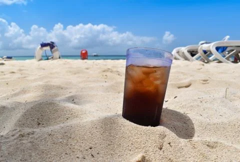 Cold drink on Caribbean beach Stock Photos