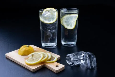 Cold drink in a glass on the kitchen table. Lemon and ice with water the best Stock Photos