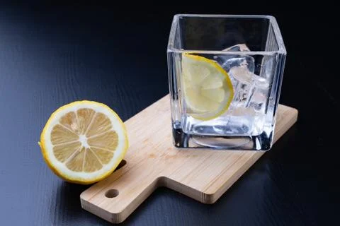 Cold drink in a glass on the kitchen table. Lemon and ice with water the best Stock Photos