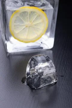 Cold drink in a glass on the kitchen table. Lemon and ice with water the best Foto stock