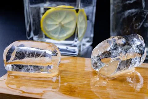 Cold drink in a glass on the kitchen table. Lemon and ice with water the best Stock Photos