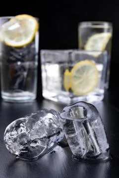 Cold drink in a glass on the kitchen table. Lemon and ice with water the best Stock Photos