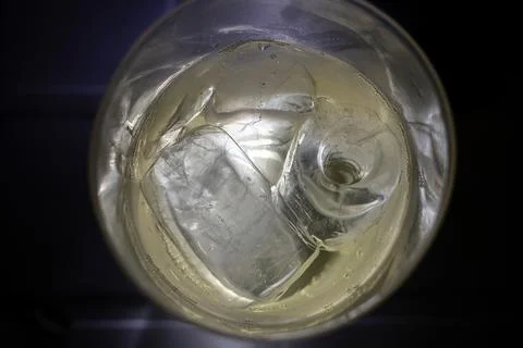 Cold drink with ice cubes and bubbles in glass Stock Photos