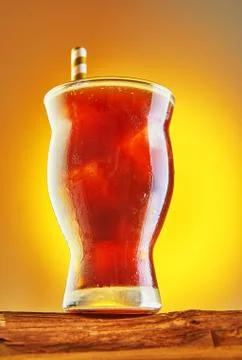 A cold drink or Nitro Coffee drink in a glass with bubble foam and ice on a w Stock Photos