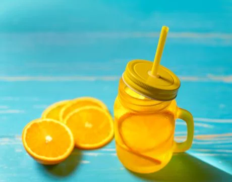 Cold drink with oranges in jar Stock Photos