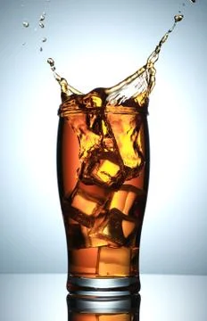 Cold Drink Splash with Ice Cubes Stock Photos