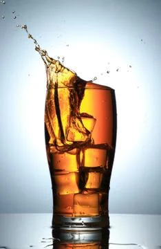 Cold Drink Splash with Ice Cubes Stock Photos