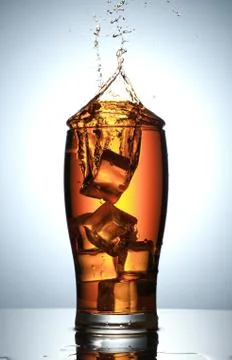 Cold Drink Splash with Ice Cubes Stock Photos