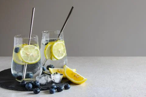 Cold drinks in small bottles. Bluecherries and lemon lemonade. Mojito coctail Stock Photos