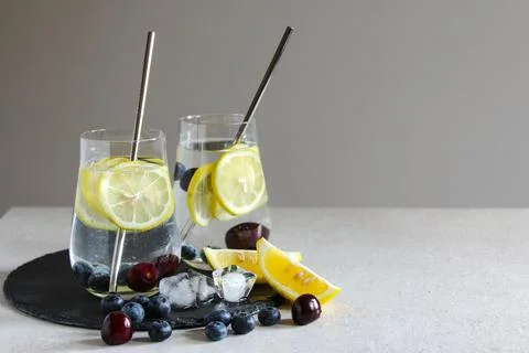 Cold drinks in small bottles. Bluecherries and lemon lemonade. Mojito coctail. Stock Photos