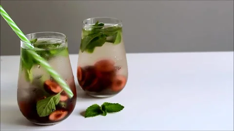 Cold drinks in small bottles. Cherries and mint lemonade. Mojito coctail. Stock Footage 156298941