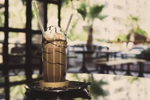 Cold fresh drink on the dark surface in the cofee shop. Stock Photos