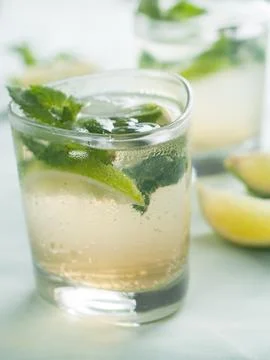 Cold fresh lemonade with lime and mint, selective focus Stock Photos