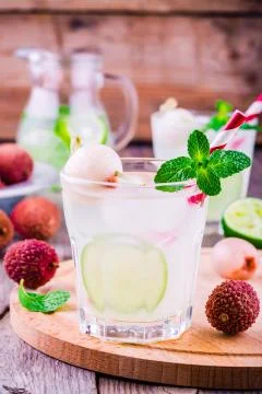Cold fresh lemonade with lychee, lime and mint in glass Stock Photos