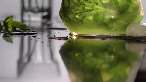 Cold fresh mojito lemonade with mint and lime in a jug. Lemonade fills a glass Stock Footage 75058957