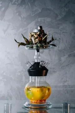Cold fruit hookah based on juice and a half of a pineapple instead of shisha  Stock Photos