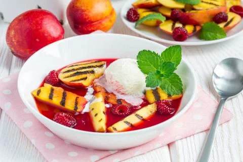 Cold fruit soup with raspberry, grilled nectarines and ice cream 스톡 사진