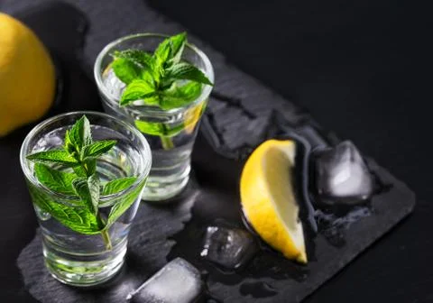 Cold gin or vodka with melted ice and lemon Foto stock