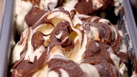 Cold ice cream covered with dark chocolate. Cold dessert concept. Stock Footage 277601915