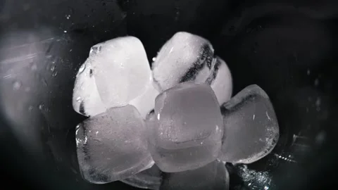 Cold Ice Cubes Melting Inside Wet Glass Against Dark Background Stock Footage 339366179