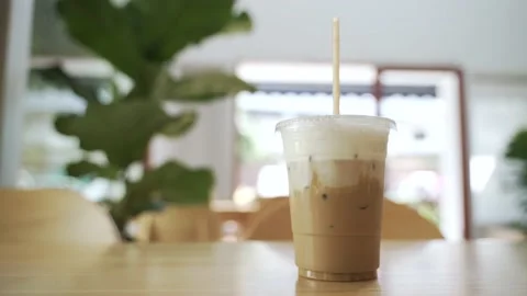 Cold ice milk coffee in a plastic cup Stock Footage 147963431