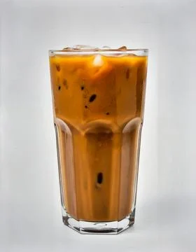 Cold Iced Coffee with Ice Cubes in Tall Glass Isolated on Light Background .. Stock Photos