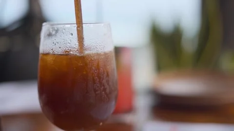 Cold Iced Drink Being Stirred In Glass Close Up Stock Footage 337066332